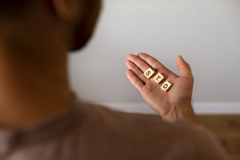 What are 3 symptoms of an STD that can occur in males?