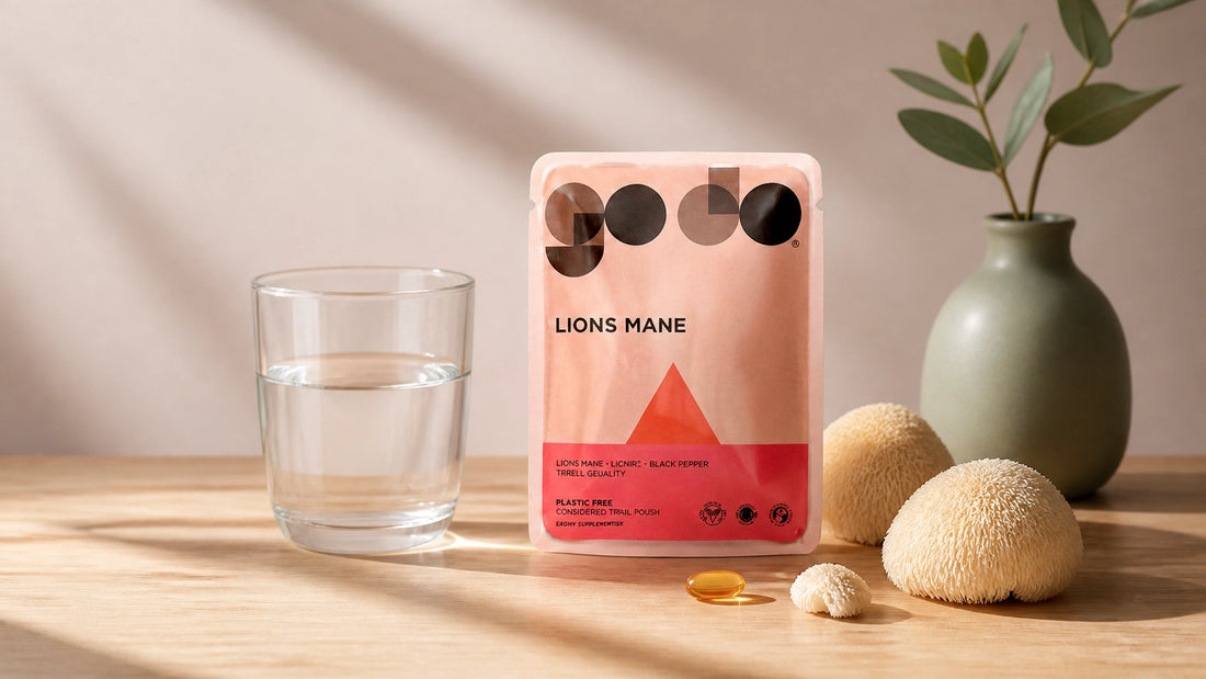 A clean, minimalistic wellness scene with a supplement pouch, water, and dried mushrooms on a soft-lit table.