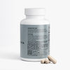 Supplement bottle with label and two capsules on a white background
